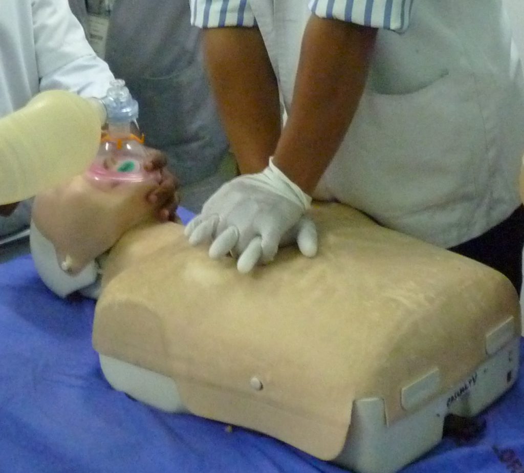 staff pressing on the chest of a cpr dummy