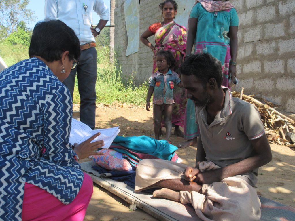 a doctor reads the medical records of a manin the jawadhi hills