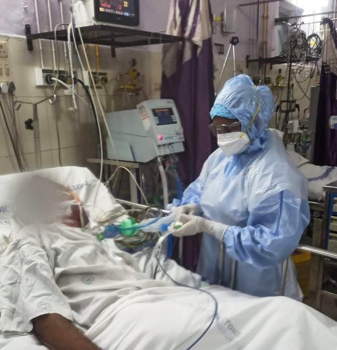 staff in ICU and full PPE tending to a patient