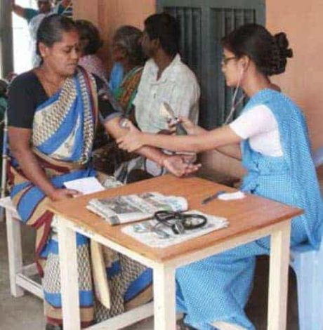 a community based nurse check the BP of a lady in the village