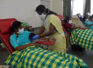 staff giving blood at a CMC blood camp