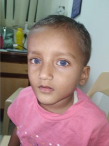 a young boy with blue eyes and Indian skin colouring