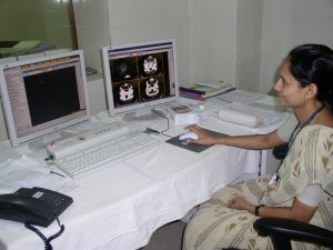 A radiodolgist is looking at an MRI scan of the brain