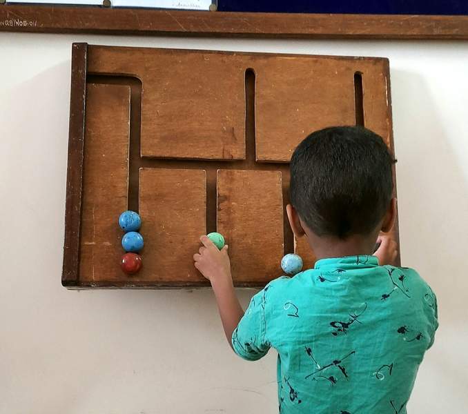 boy playing with puzzle on the wall