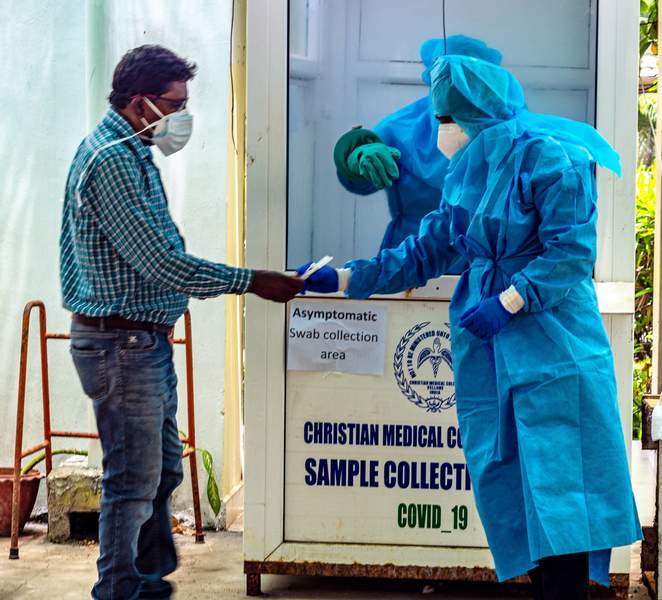 person hands over swab to the outside staff