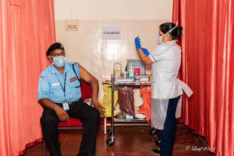 The nurse gets the vaccination ready