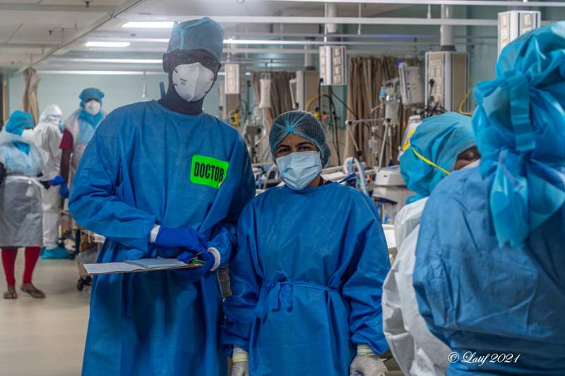 staff in the Kannigapuram ICU in full ppe caring for patients on ventilators with COVID